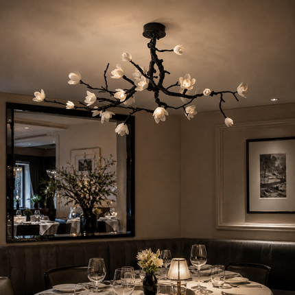 Illuminated Arborielle ceramic flower ceiling light above a restaurant dining table