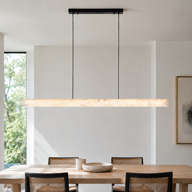 Nevella snowflake alabaster linear pendant light above a rectangular wood dining table