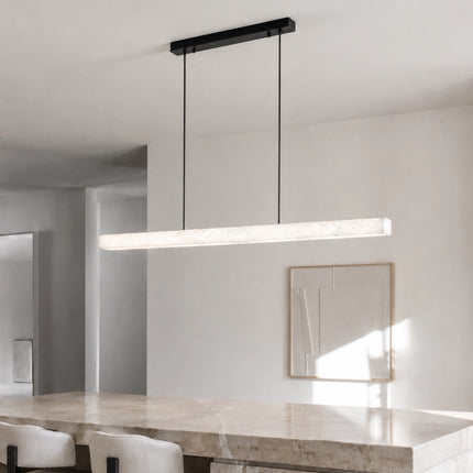 Nevella linear pendant light suspended above a stone kitchen island