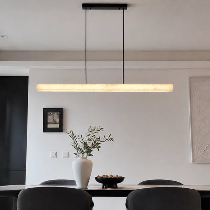 Nevella minimalist alabaster pendant light above a black dining table