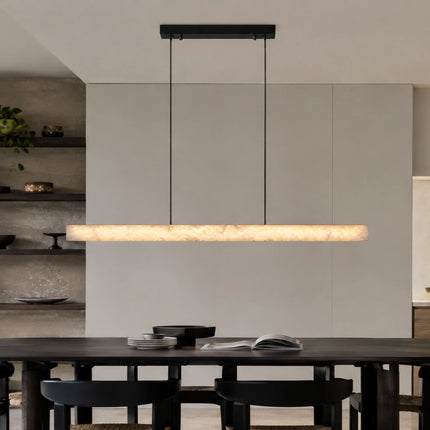 Nevella snowflake alabaster pendant light illuminating a dark dining table