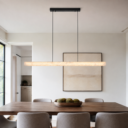Nevella linear LED pendant light illuminating a contemporary dining table