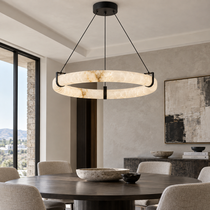 Anulora alabaster chandelier above a dark round table in a bright dining room