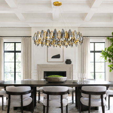 Navette smoke gray crystal chandelier above a large dining table in a bright interior
