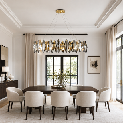 Navette smoke gray crystal chandelier above a rectangular table in a neutral dining room