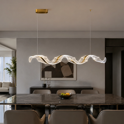 Tidal Ribbon linear chandelier above a modern marble dining table