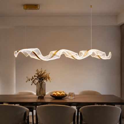 Tidal Ribbon Chandelier providing warm light above a dining table