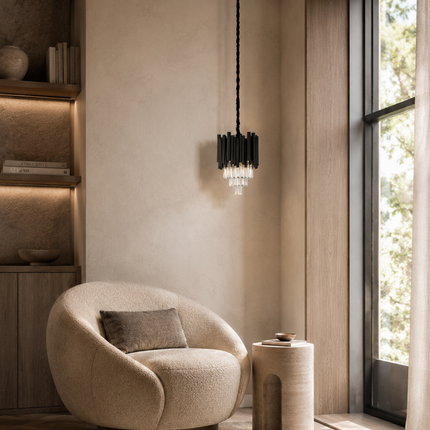 Virelle black metal crystal pendant light beside a curved chair in a sunlit reading corner