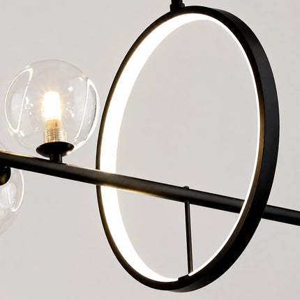 Close-up of the illuminated ring and clear glass globe on the Virelune chandelier